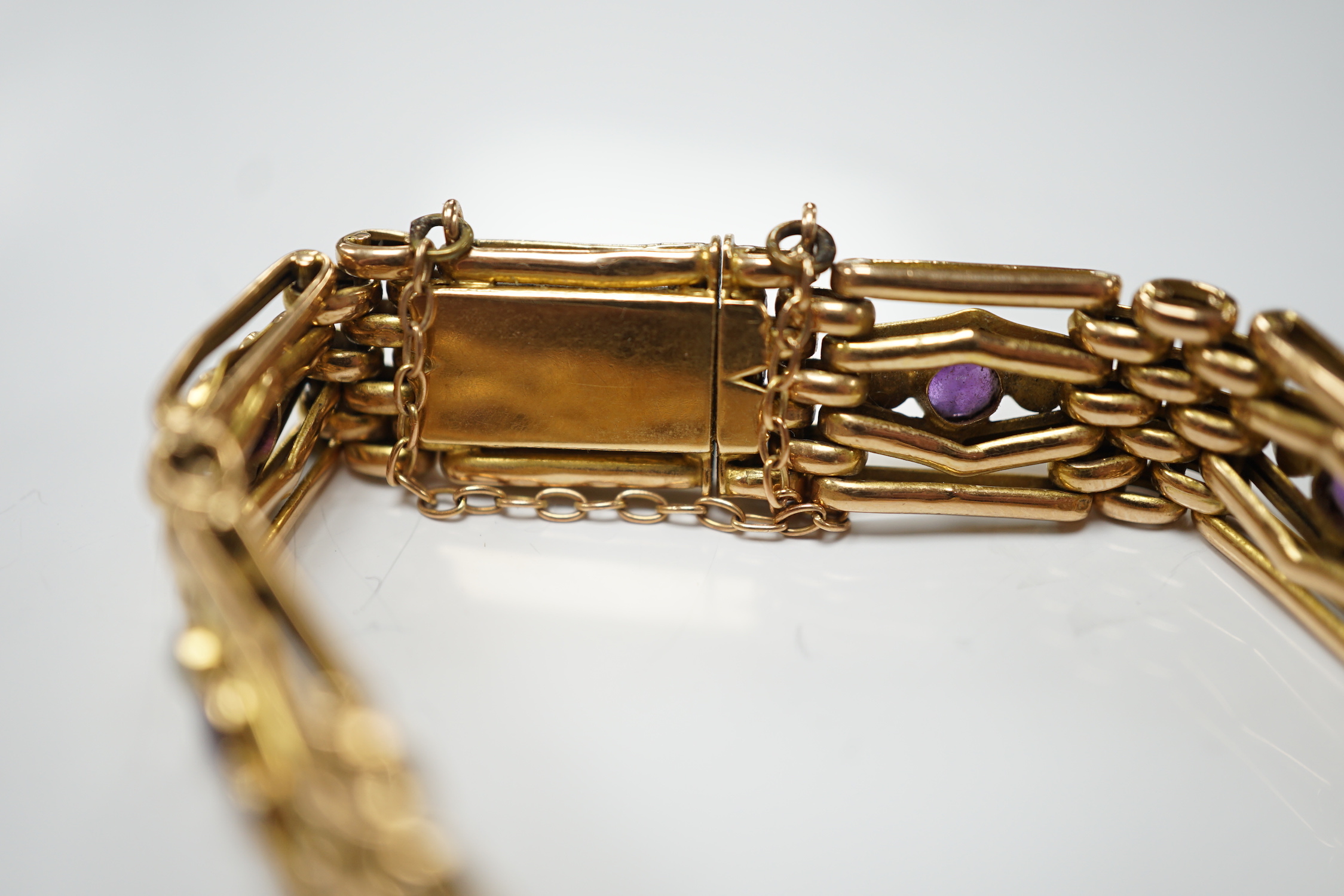 An Edwardian 15ct, amethyst and seed pearl set gate link bracelet, 18cm